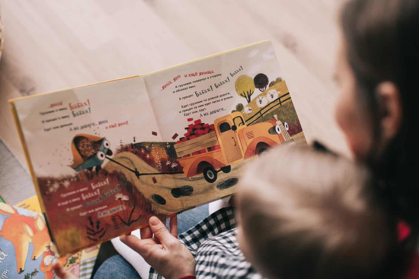 Nanny reading a book to a child